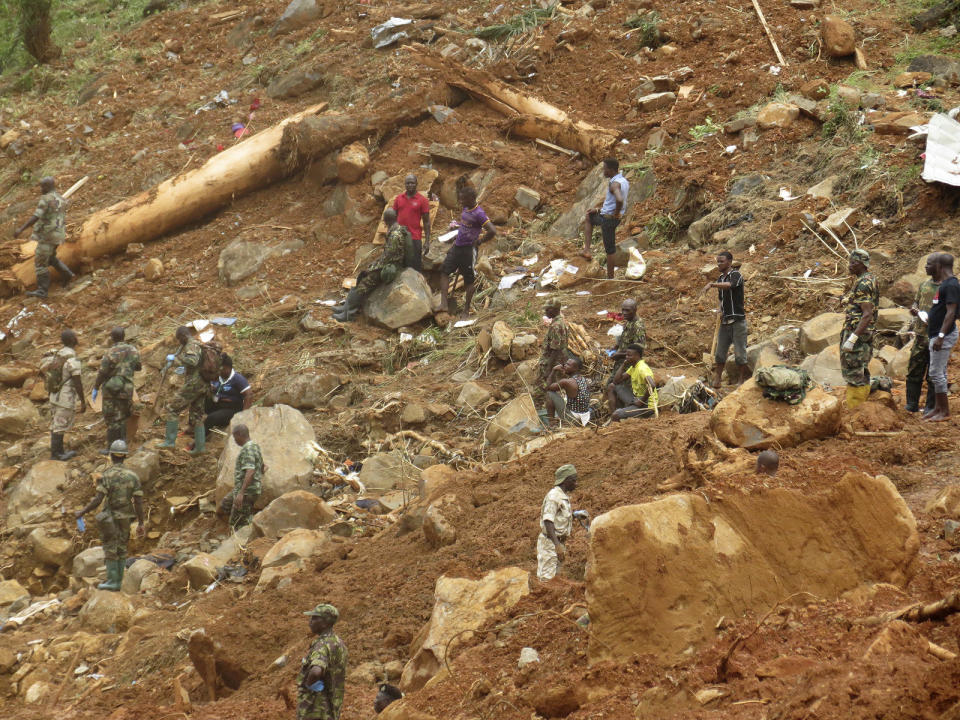 <p>Security forces search for bodies from the scene of heavy flooding and mudslides in Regent, just outside of Sierra Leone’s capital Freetown, Aug. 15 , 2017. (Photo: Manika Kamara/AP) </p>