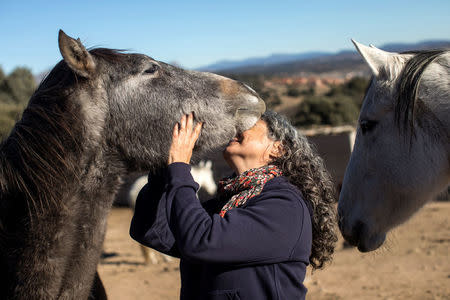 Loreto Garcia, patient of emotional therapist Fernando Noailles, embraces a horse in Guadalix de la Sierra, outside Madrid, Spain, December 4, 2017. REUTERS/Juan Medina