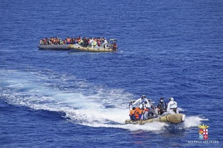 Migrants sit in a rescue boat during a rescue operation by Italian Navy vessels off the coast of Sicily in this April 11, 2016 handout picture provided by Marina Militare. REUTERS/Marina Militare/Handout via Reuters