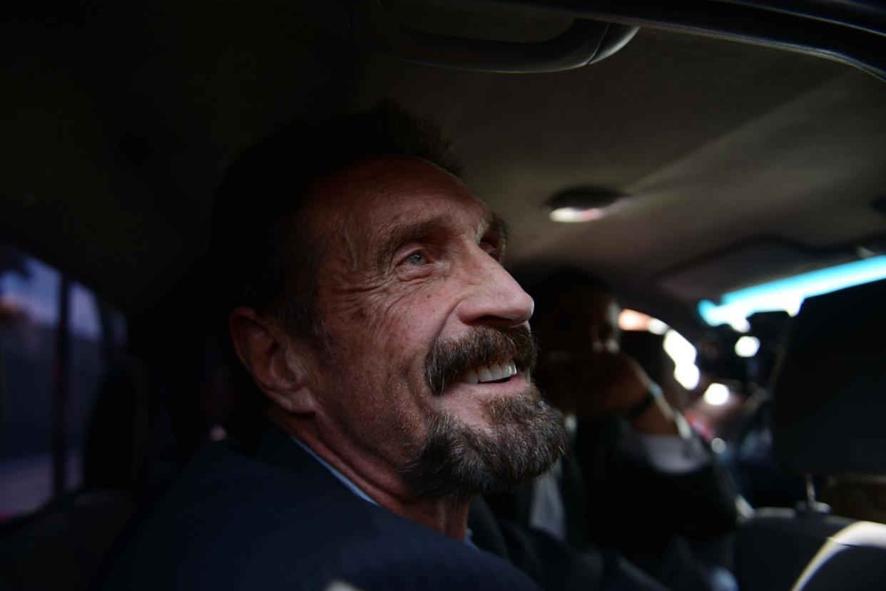 US anti-virus software pioneer John McAfee smiles as he arrives at the Aurora international airport in Guatemala City on December 12, 2012. Mr McAfee was found dead in his prison cell in Spain on Wednesday, 23 June, 2021. (AFP via Getty Images)