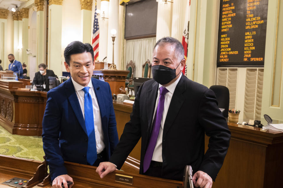 FILE - Assemblyman Evan Low, D-San Jose, and Phil Ting, D-San Francisco, chat following the opening session of the California Assembly in Sacramento, Calif., Wednesday, Jan. 4, 2023. California lawmakers are going to try to introduce legislation Tuesday, Feb. 14, 2023, to officially repeal a 15-year-old voter initiative meant to ban same-sex marriage in the state. (AP Photo/José Luis Villegas,File)