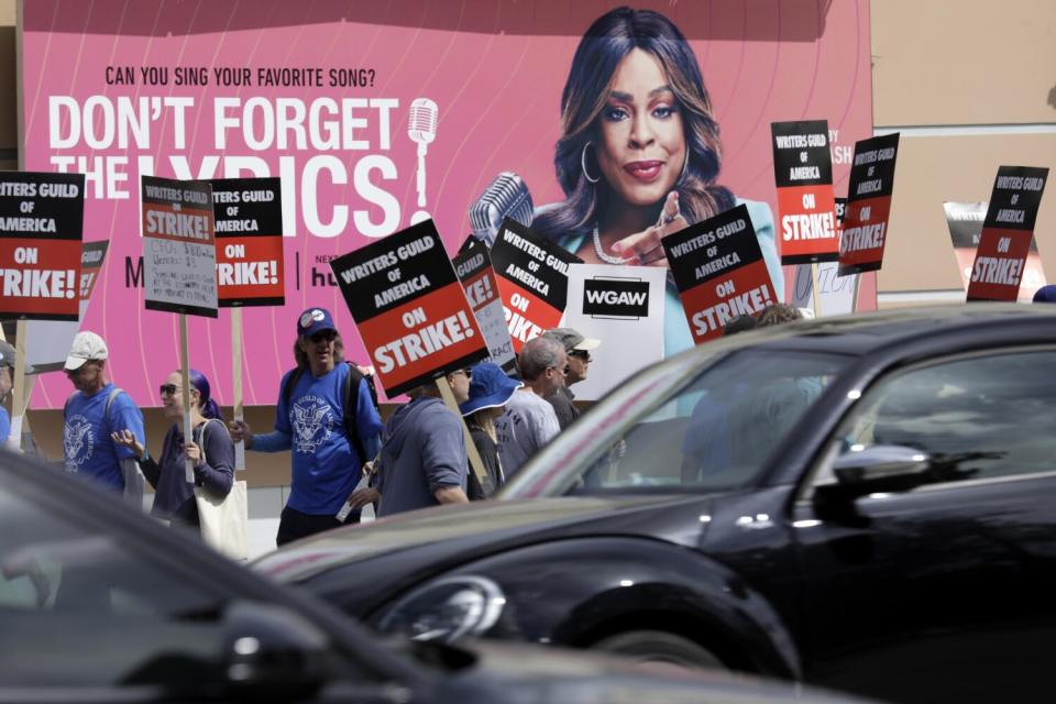 WGA members walk the picket line in front of Fox Studios