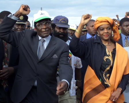 FILE PHOTO - Zimbabwe President Robert Mugabe arrives with his wife Grace for an election rally in Madziwa