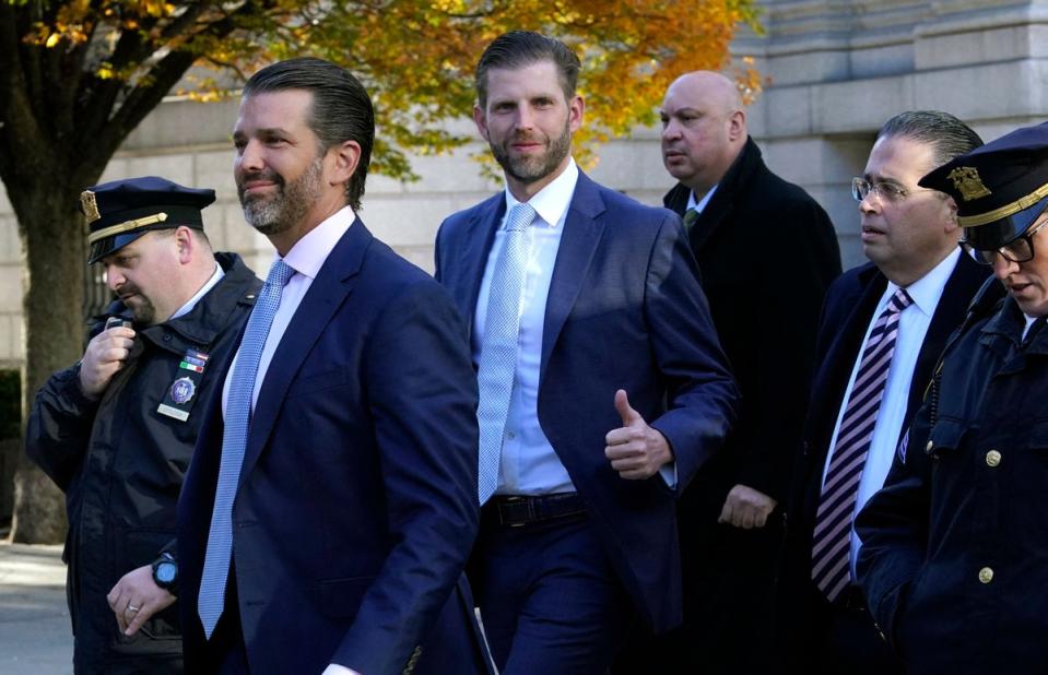 Donald Trump  Jr (2nd L) and Eric Trump (3rd L) arrive at New York Supreme Court on 2 November 2023, for the fraud trial of the Trump Organization (AFP via Getty Images)