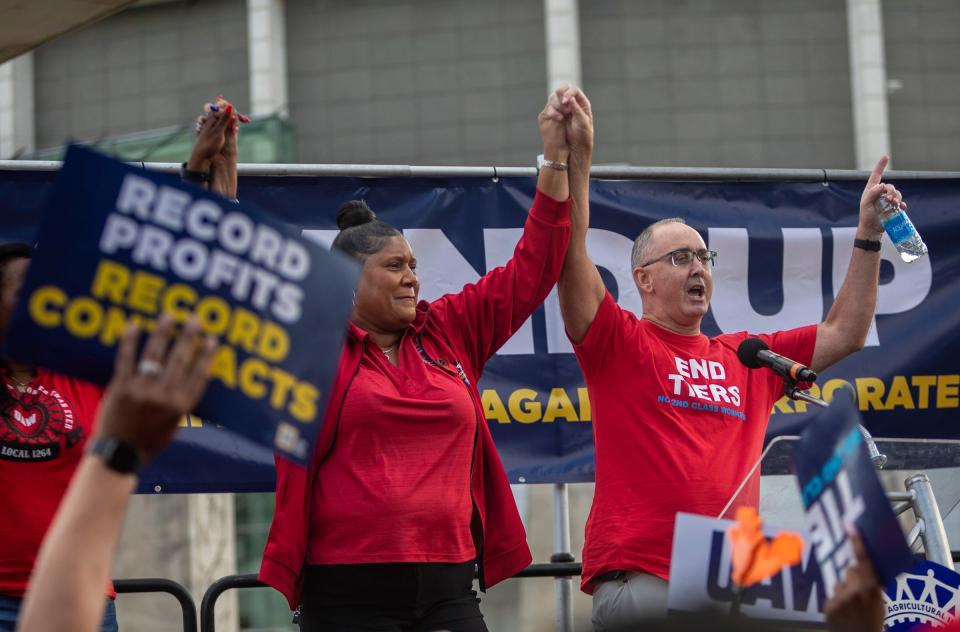 Laura Dickerson holds hands with UAW President Shawn Fain in front of dozens of United Auto Workers and community members during a rally outside the UAW-Ford Joint Trusts Center in Detroit on Friday, Sept. 15, 2023.