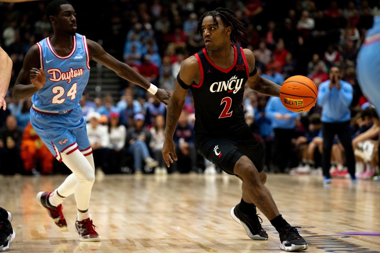 Cincinnati Bearcats guard Jizzle James (2) drives on Dayton Flyers guard Kobe Elvis (24) in the second half of the game betweenUC and UD at Heritage Bank Center last December.