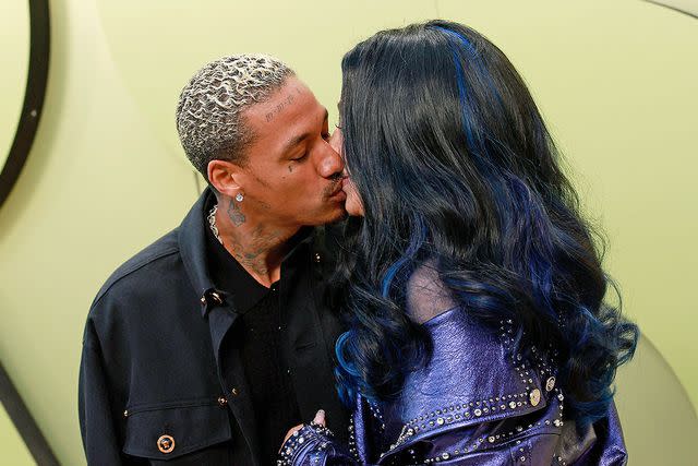 MICHAEL TRAN/AFP via Getty Alexander "AE" Edwards kisses girlfriend Cher in March 2023