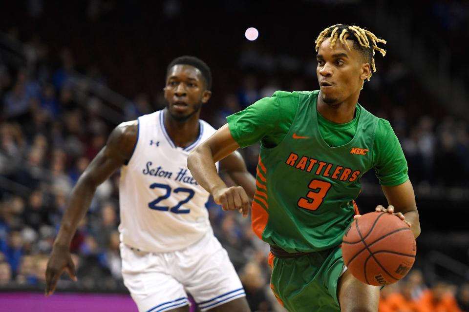 Florida A&M guard MJ Randolph (3) dribbles the ball as Seton Hall guard Myles Cale (22) gives chase during the first half of an NCAA college basketball game, Saturday, Nov. 23, 2019 in Newark, N.J. (AP Photo/Sarah Stier)