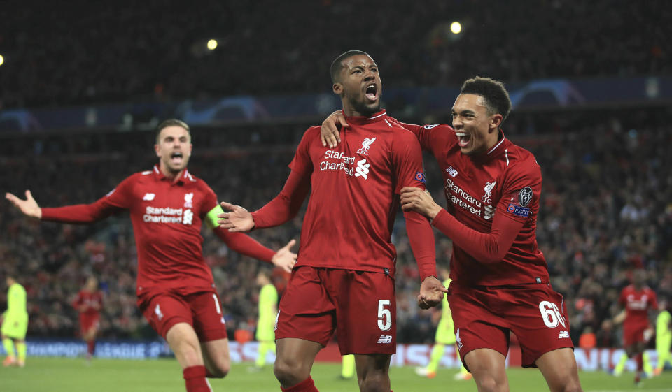 Liverpool's Georginio Wijnaldum, center, celebrates scoring his side's third goal of the game during the Champions League Semi Final, second leg soccer match between Liverpool and Barcelona at Anfield, Liverpool, England, Tuesday, May 7, 2019. (Peter Byrne/PA via AP)