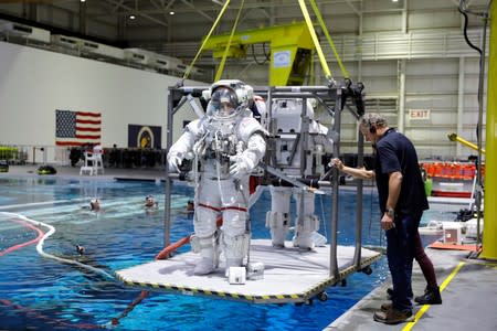 NASA Commercial Crew astronauts Sunita Williams and Josh Cassada are seen lowered into the water at NASA's Neutral Buoyancy Laboratory (NBL) training facility near the Johnson Space Center in Houston