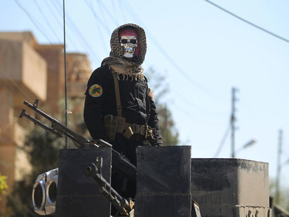 An Iraqi soldier stands guard in Mosul's al-Jadida area, where air strikes have killed a large number of civilians in recent days: AFP/Getty