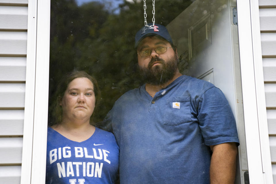 Image: Natasha Skidmore and Gregory Chase Hays in the front door of their house in the Upper River Caney community of Lost Creek, Ky., on Aug. 18, 2022. (Michael Swensen for NBC News)
