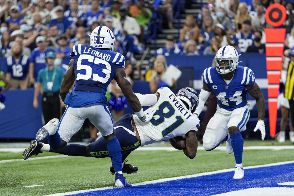 Seattle Seahawks tight end Gerald Everett (81) scores a touchdown between Indianapolis Colts outside linebacker Darius Leonard (53) and outside linebacker Zaire Franklin (44) during the first half of an NFL football game in Indianapolis, Sunday, Sept. 12, 2021. (AP Photo/AJ Mast)