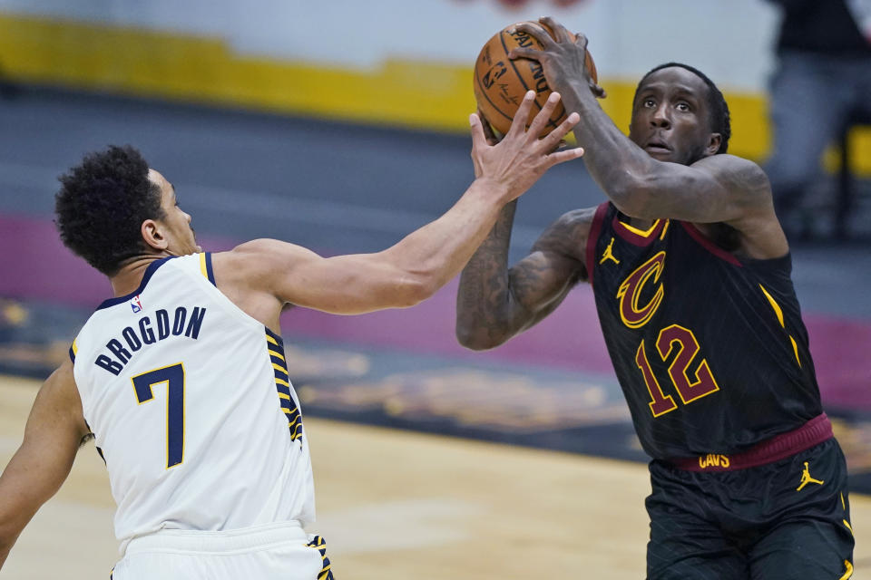 Cleveland Cavaliers' Taurean Prince (12) drives to the basket against Indiana Pacers' Malcolm Brogdon (7) during the first half of an NBA basketball game Wednesday, March 3, 2021, in Cleveland. (AP Photo/Tony Dejak)