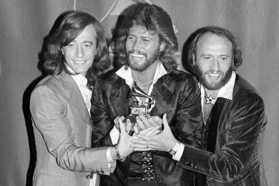 Grammy winners 2/15 the Bee Gees, brothers Robin, Barry and Maurice Gibb hold their Grammy for their Album of the Year Award, "Saturday Night Fever," the largest selling soundtrack in album history with 15-million sold. The Bee Gees won four Grammys but lost out to Billy Joel and the song "Just the Way You Are" for the coveted awards for Record and Song of the Year.