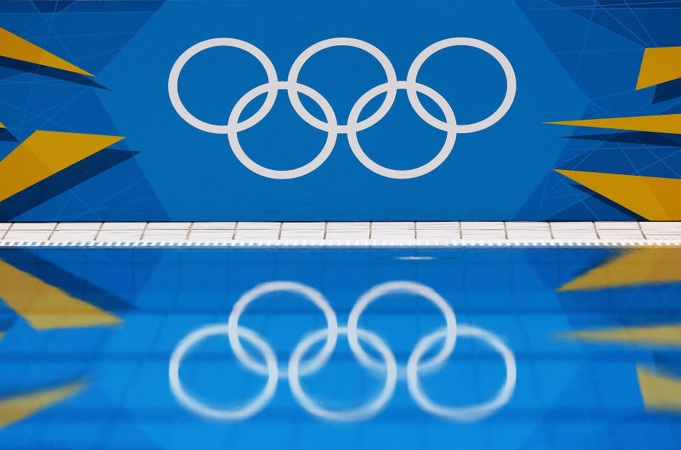 LONDON, ENGLAND - JULY 26: A detail of the Olympic Rings reflects in the pool water during a training session ahead of the London Olympic Games at the Aquatics Centre in Olympic Park on July 26, 2012 in London, England. (Photo by Clive Rose/Getty Images)