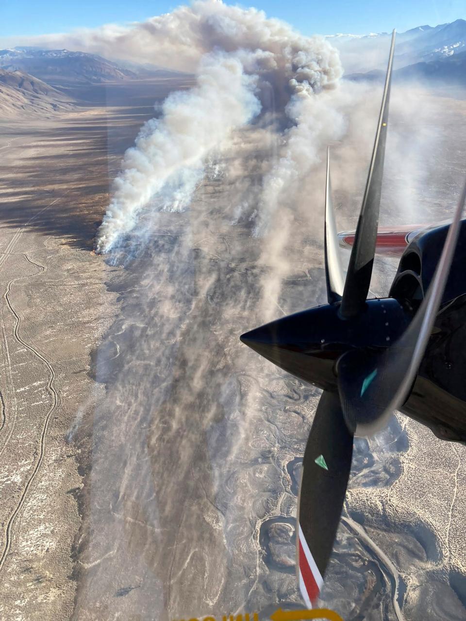 This photo provided by CAL FIRE San Bernardino Unit Public Information Office shows smoke from a blaze that erupted Wednesday, Feb. 16, 2022, near Eastern Sierra Regional Airport just outside the town of Bishop, Calif., in the Owens Valley, according to the California Department of Forestry and Fire Protection, or Cal Fire.