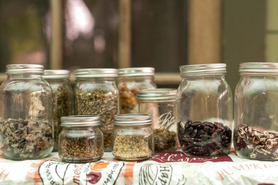 Glass Mason jars filled with various seeds.