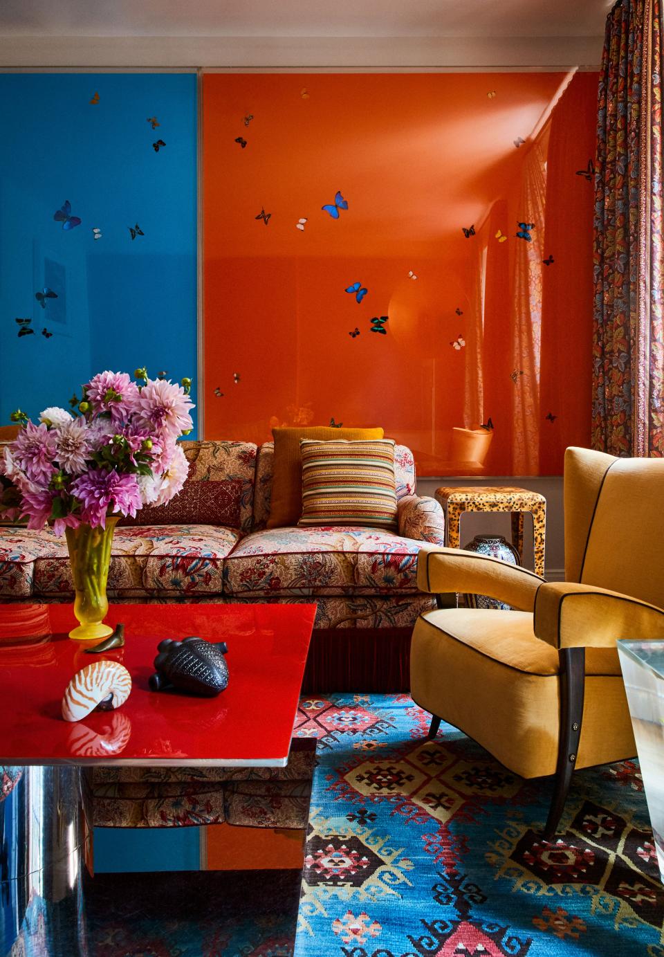 Another view of the sitting room, where a nautilus shell, a Carl Auböck brass foot, and a Mexican black clay heart adorn a Martin Szekely cocktail table.