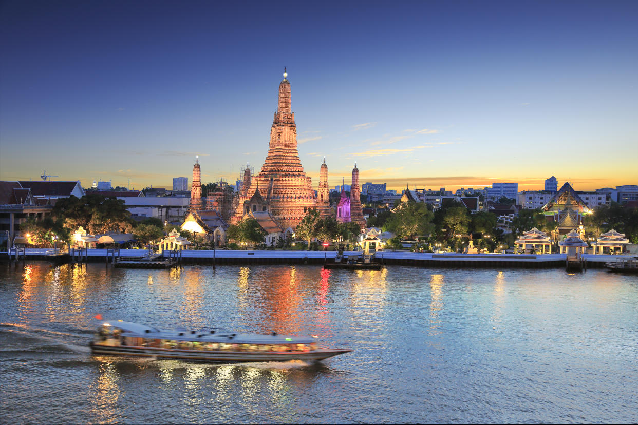 Wat Arun and cruise ship in twilight time, Bangkok, Thailand, on the Thonburi west bank of the Chao Phraya River. (Photo: Getty Images)