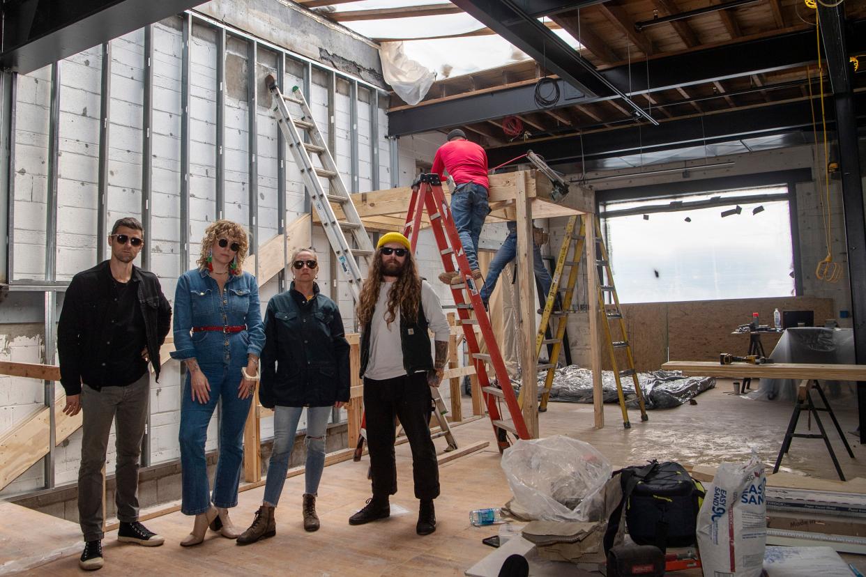 From left, Doug Reiser, Kristen Oxtoby, Jess Reiser, and Bryce Franich, pose for a picture as construction continues on Eulogy, Burial Beer Co.’s bar and music venue.