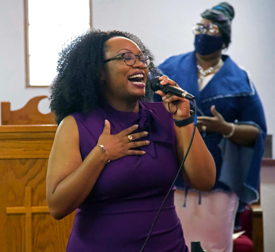 Deaconess Petrina Adams leads praise and worship service at Pilgrim Rest Church of God In Unity in Gainesville on Sunday in northeast Gainesville.