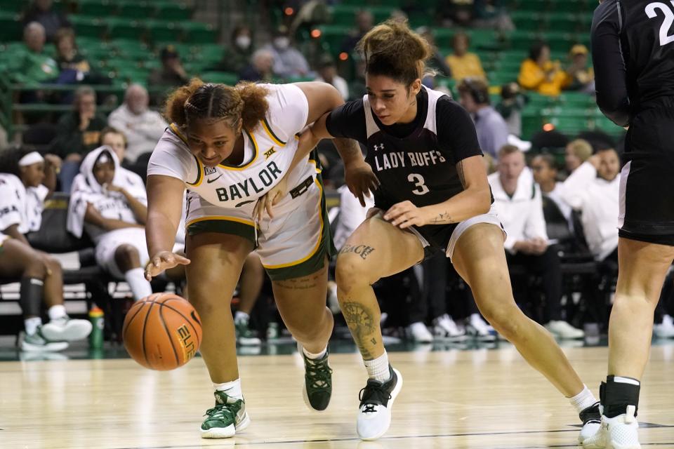 Baylor forward Kendra Gillispie (25) and West Texas A&M guard Haylei Janssens (3) compete for control of a loose ball in the second half of an exhibition NCAA college basketball game in Waco, Texas, Wednesday, Nov. 3, 2021. (AP Photo/Tony Gutierrez)