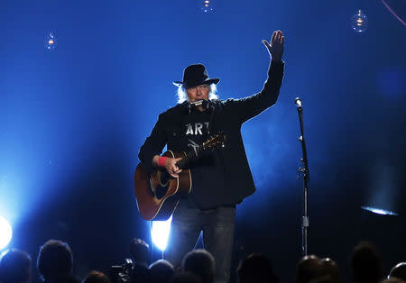 FILE PHOTO: Musician Neil Young performs "Blowin' in the Wind" during the 2015 MusiCares Person of the Year tribute honoring Bob Dylan in Los Angeles, California February 6, 2015. REUTERS/Mario Anzuoni