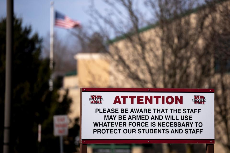 A sign in front of Locust Corner Elementary School informs the public that their staff may be armed at the school. The sign is part of the policy required by the New Richmond school district in order to allow staff members access to firearms on school premises.