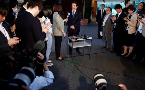 Japan's Prime Minister Shinzo Abe speaks to media after Trump's news conference - Credit: Issei Kato/Reuters