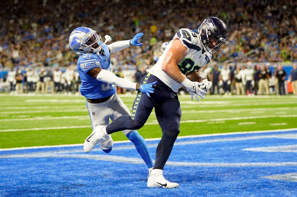 Seattle Seahawks tight end Will Dissly (89), defended by Detroit Lions safety Kerby Joseph runs into the end zone for a touchdown during the first half of an NFL football game, Sunday, Oct. 2, 2022, in Detroit. (AP Photo/Paul Sancya)