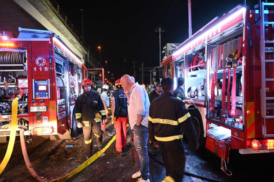 Firefighters work on the site of the accident (AFP via Getty Images)