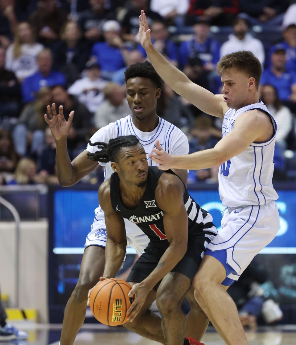Brigham Young Cougars guards Jaxson Robinson (2) and Dallin Hall (30) defend Cincinnati Bearcats guard Day Day Thomas (1) in Provo on Saturday, Jan. 6, 2024. | Jeffrey D. Allred, Deseret News
