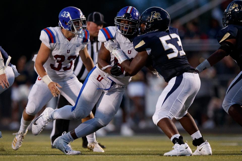 Dion Stutts (62) of MUS and Tre Jones (53) of Arlington  during the game between the Arlington Tigers and MUS Owls on Friday August, 19th 2022 in Arlington, Tn (Justin Ford/Special to the Commercial Appeal)