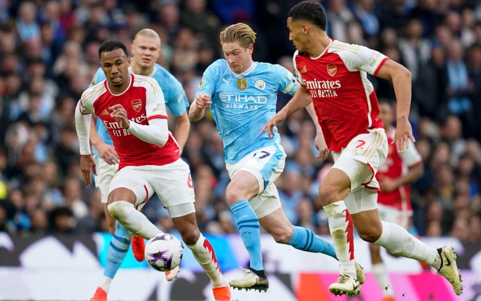 Arsenal's in-form defensive pairing of Saliba and Gabriel close down Kevin de Bruyne during the 0-0 draw with Man City