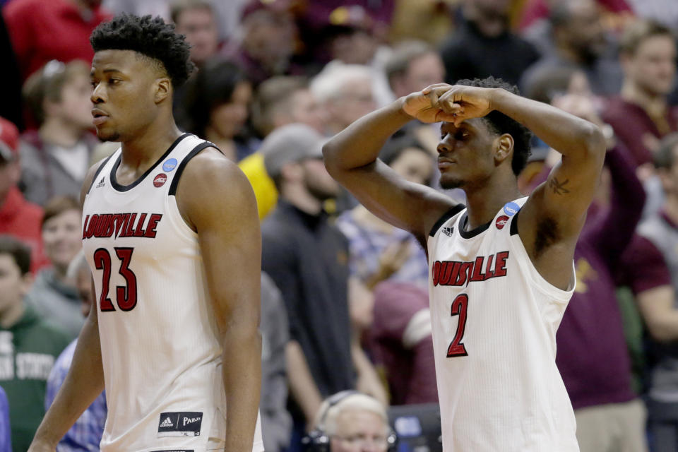 <p>Louisville’s Darius Perry (2) and Steven Enoch (23) walk off the court following their 86-76 loss to Minnesota in a first round men’s college basketball game in the NCAA Tournament, in Des Moines, Iowa, Thursday, March 21, 2019. (Nati Harnik/AP) </p>