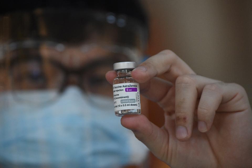 FILE PHOTO: A health worker holds a vial of the AstraZeneca/Oxford&#39;s COVID-19 coronavirus vaccine inside a Catholic church turned into a vaccination center in Manila on May 21, 2021. (Photo: TED ALJIBE/AFP via Getty Images)