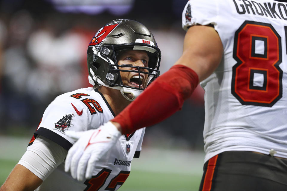 Tampa Bay Buccaneers quarterback Tom Brady celebrates with tight end Rob Gronkowski after the two connected on a touchdown against the Atlanta Falcons during an NFL football game, Sunday, Dec 5, 2021, in Atlanta. (Curtis Compton/Atlanta Journal-Constitution via AP)