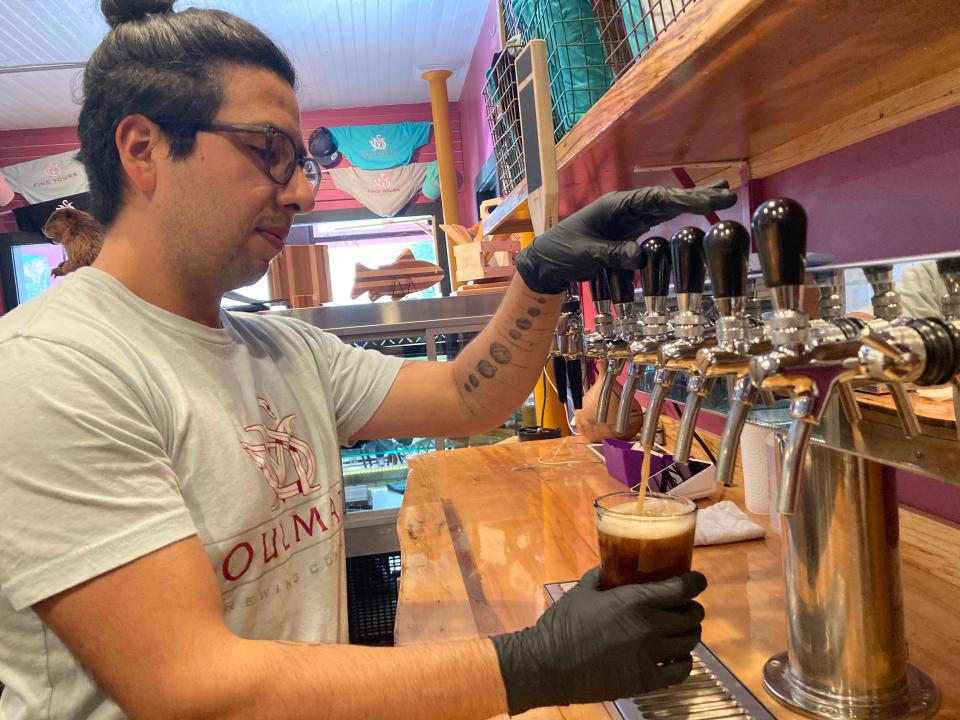 Hideki Arao, brewer at Soulmate Brewing in Morrisville, pours an I'd Drink Me, an Irish red ale, Sept. 14, 2023.