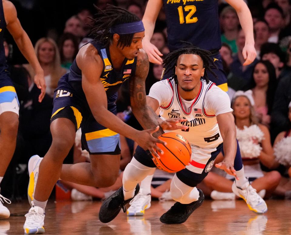 Mar 16, 2024; New York City, NY, USA; Marquette Golden Eagles guard Tre Norman (5) and Connecticut Huskies guard Stephon Castle (5) fight for a loose ball in the second half at Madison Square Garden. Mandatory Credit: Robert Deutsch-USA TODAY Sports