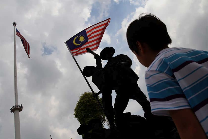 A boy looks at a replica of Tugu Negara at Dataran Merdeka in Kuala Lumpur. — Picture by Yusof Mat Isa