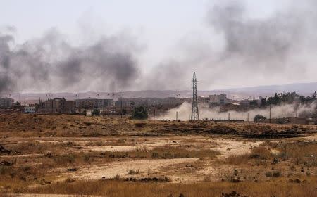 Smoke rises after what Kurdish People's Protection Units (YPG) fighters said was shelling by them on locations controlled by Islamic State fighters in Ghwayran neighborhood in Hasaka city, Syria July 22, 2015. REUTERS/Rodi Said