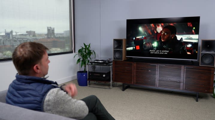 A man watches a program on a Roku. Plus Series TV.