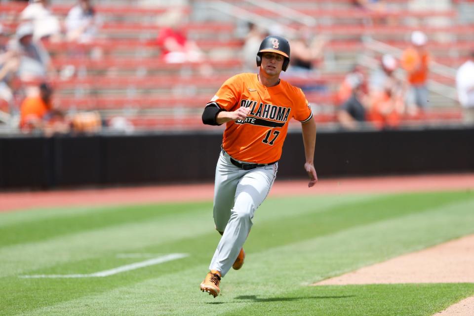 Oklahoma State utility Jake Thompson rounds third while scoring a run against Missouri State during an NCAA college baseball tournament regional game Sunday, June 5, 2022, in Stillwater, Okla. (Ian Maule/Tulsa World via AP)