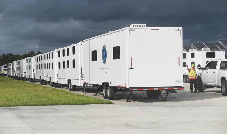 Sleeping quarters for workers begin to arrive at American Muscle Car Museum in Melbourne on Thursday for electrical workers who will restore power to Floridians affected by Hurricane Nicole.