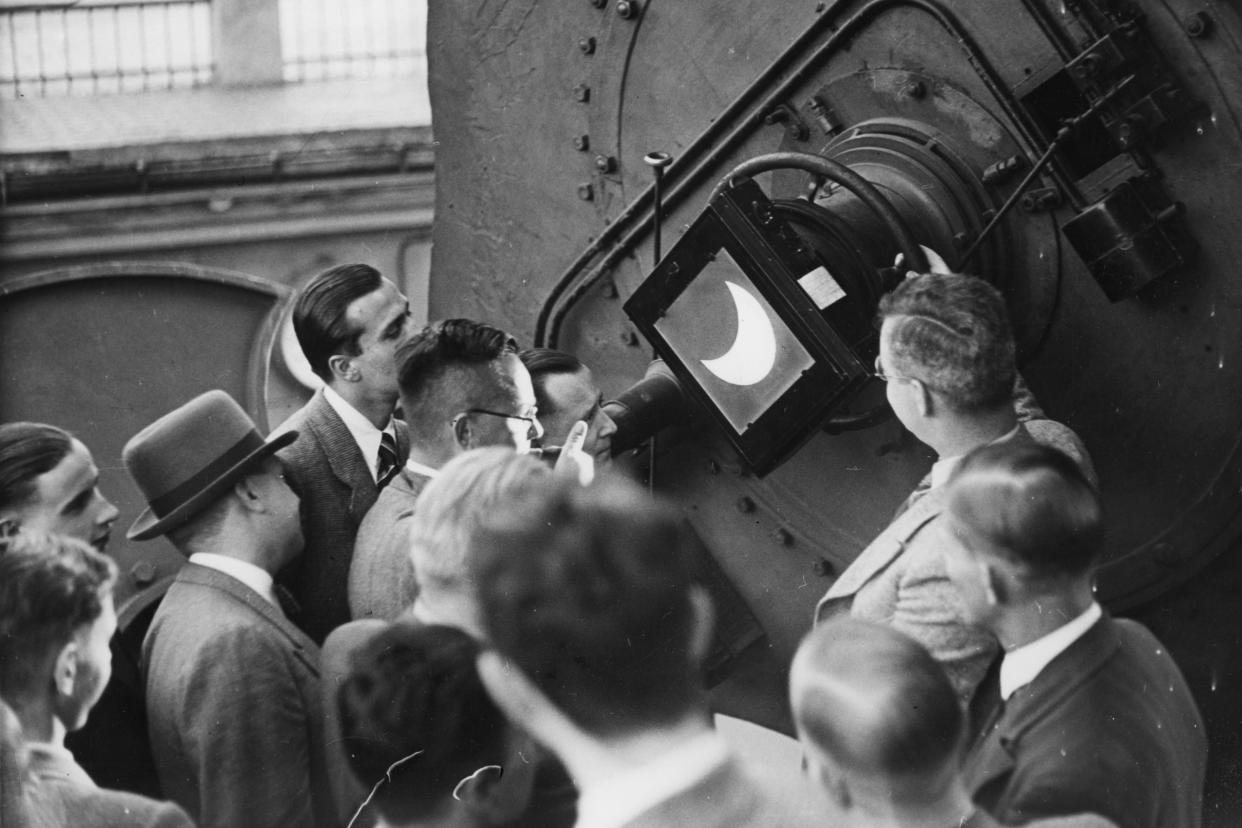 1936: Visitors to the Treptower astronomical observatory in Berlin view an eclipse. 