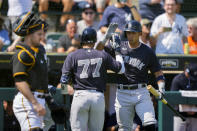 New York Yankees Anthony Volpe (77) is greeted by Cabrera Oswaldo after hitting a leadoff solo home run in the first inning of a MLB spring training baseball game against the Pittsburgh Pirates in Bradenton, Fla., Thursday, March 2, 2023. (AP Photo/Gerald Herbert)