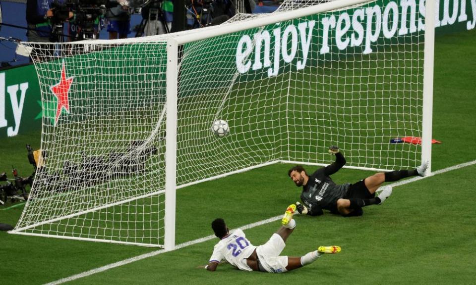 Vinícius Júnior slides in to score Real Madrid’s winner against Liverpool.