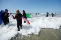 Senior women gather to boogie board on International Women's Day in Solana Beach, California