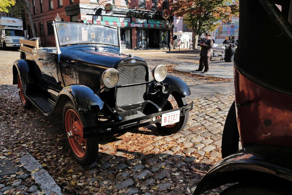 Vintage cars are parked on the side of Acushnet Avenue as filming continues on a TV series, 'Invitation to a Bonfire,' set in the 1930s, is being filmed in downtown New Bedford.